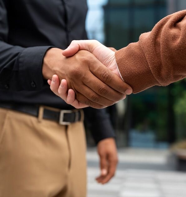Two business partners shaking hands, symbolizing trust and long-term support from Global Fuels for independent gas station owners